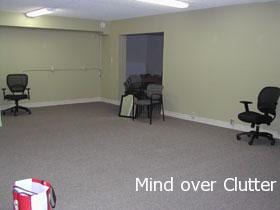 An empty room with carpeting and yellow walls