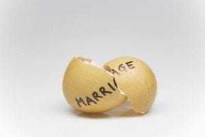a yellow ball with the word marriage on it.  The ball is cracked in half. 