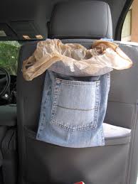 Place a garbage bag in the back seat by hanging it over the head rest.