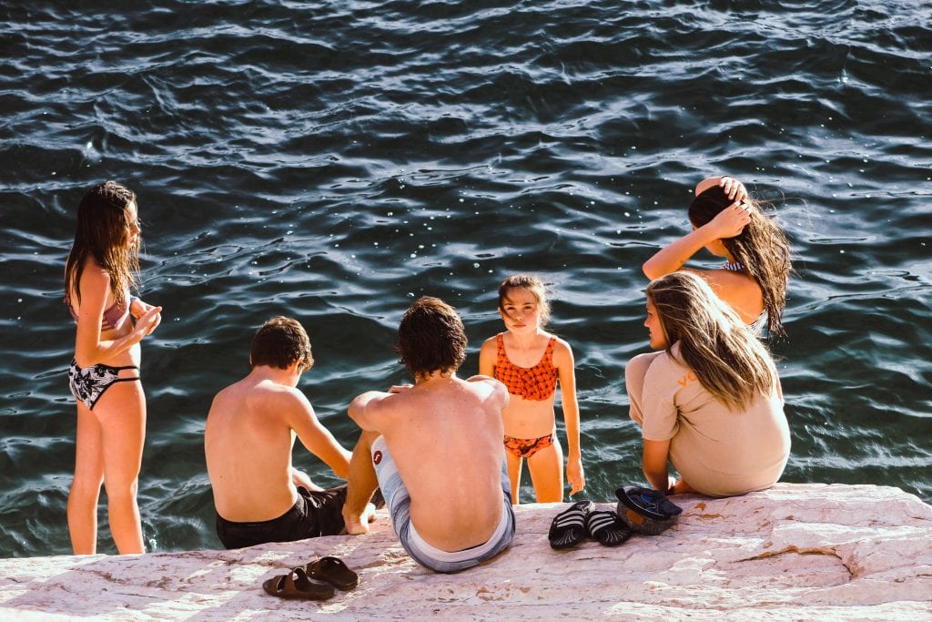 Summer fun with 5 children swimming at a lake. 