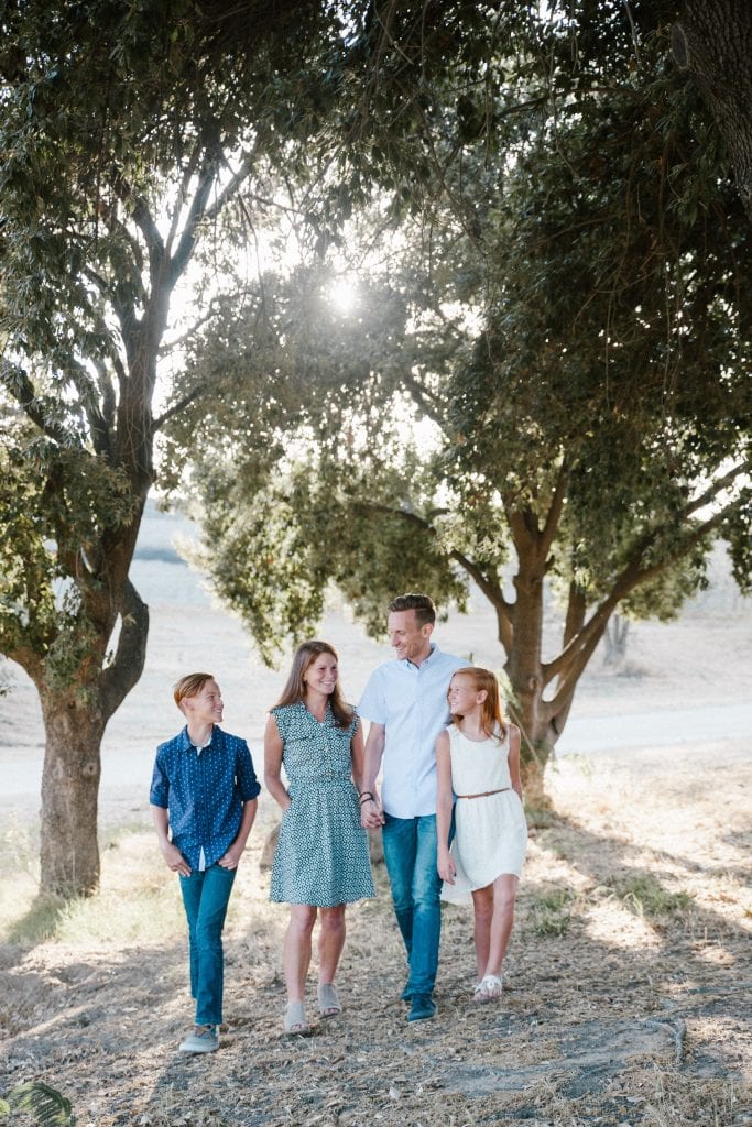 A family walking in the trees enjoying time together in the summer. 