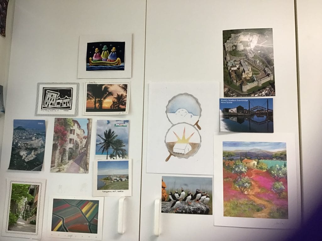 White cupboard door with pictures on it. 