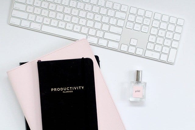 A productivity planner next to a keyboard
