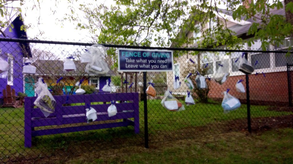 Donations tied to a fence for people to take.