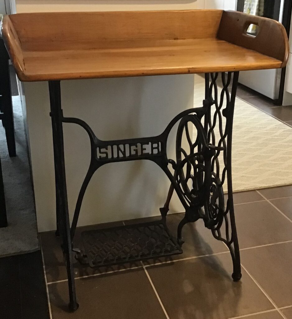 A treadel sewing machine made into a table. 