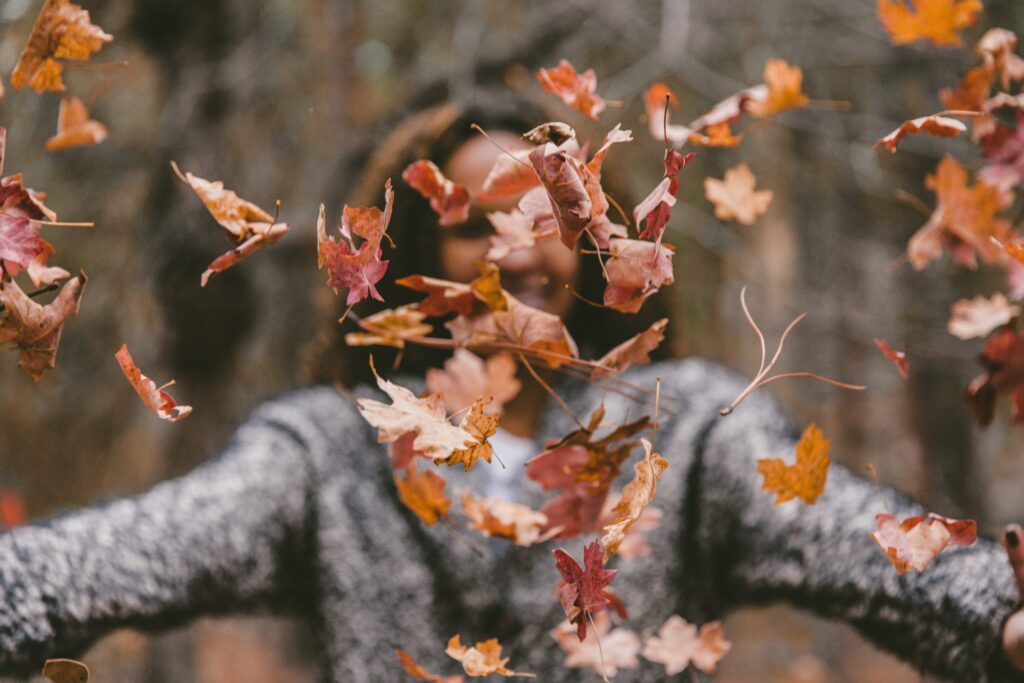 Walking and throwing leaves into the air