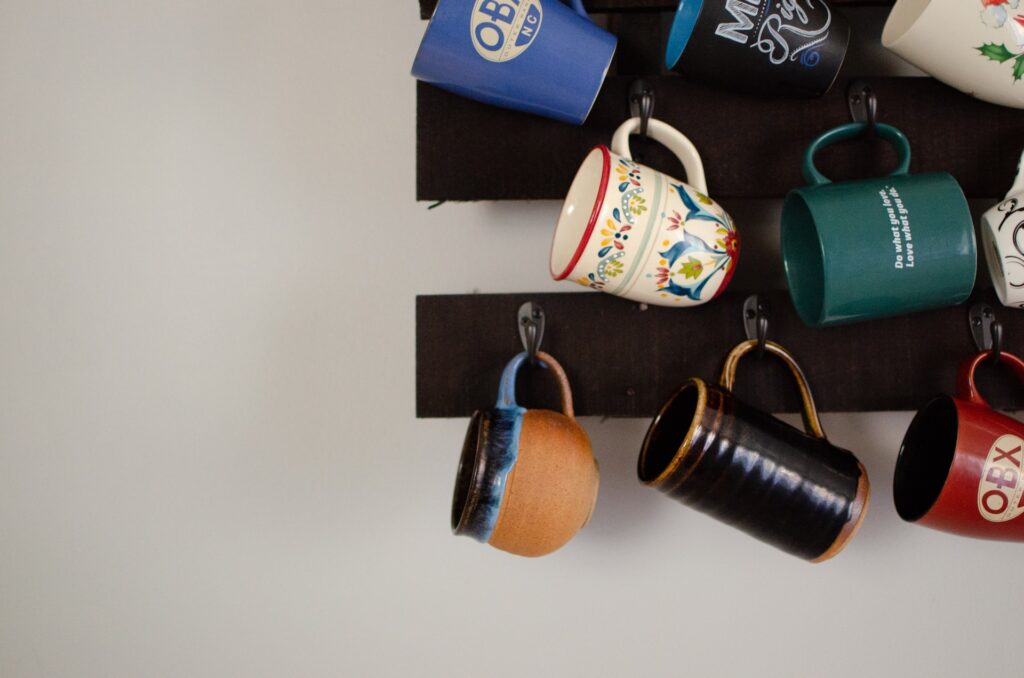 A wall mounted mug rack to hold coffee mugs 