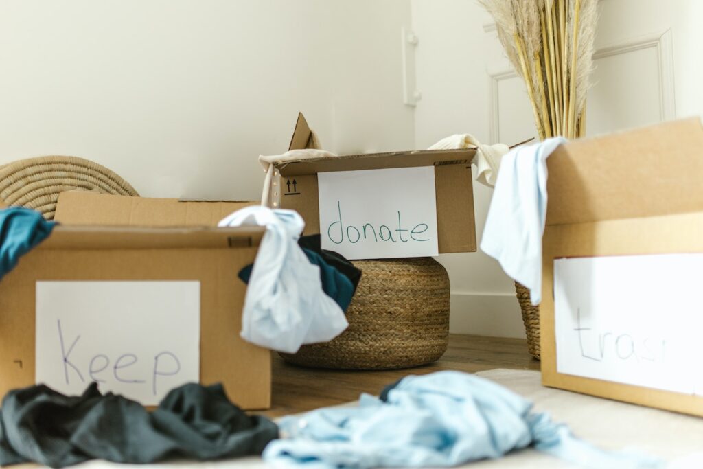 3 boxes on the floor labelled donate trash and keep.