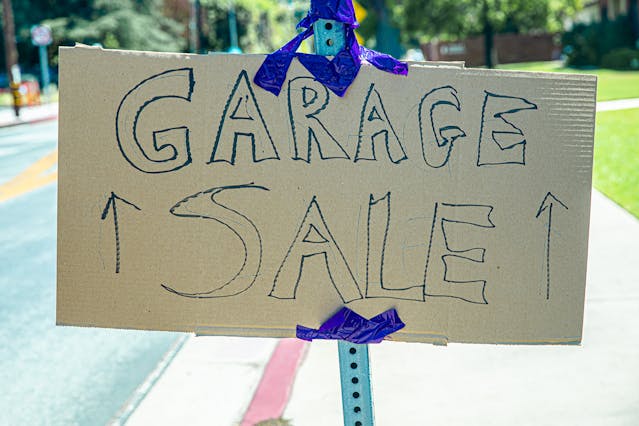 Handwritten “Garage Sale” sign on cardboard