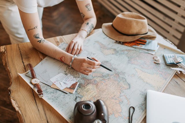 A person drawing on a world map with a pen