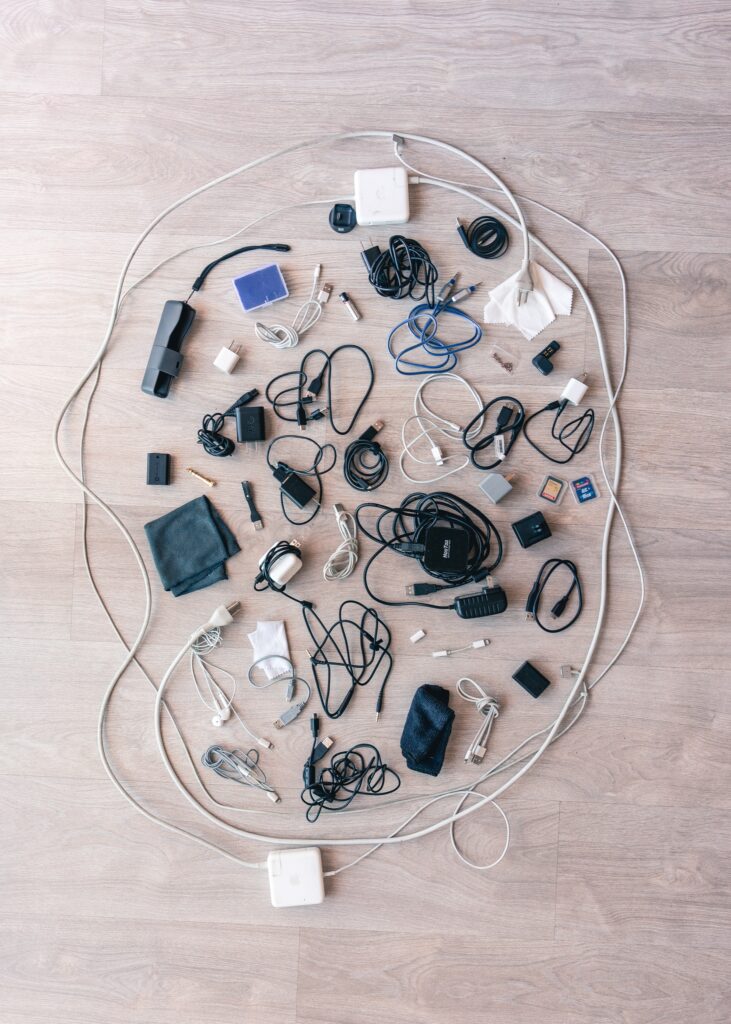 A circle of a variety of electronic cables and earbuds. 