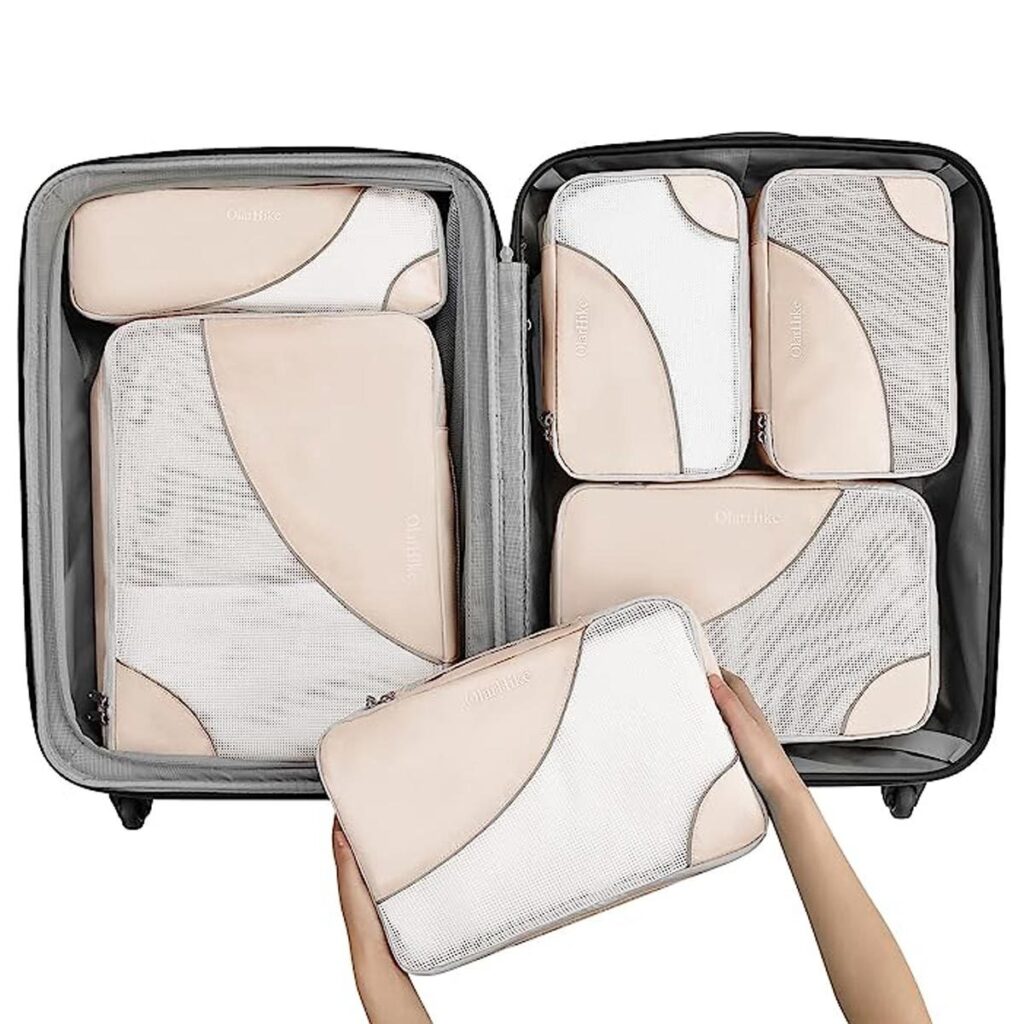 Beige packing cubes in a suitcase. 