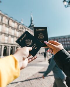 2 people each holding a passport