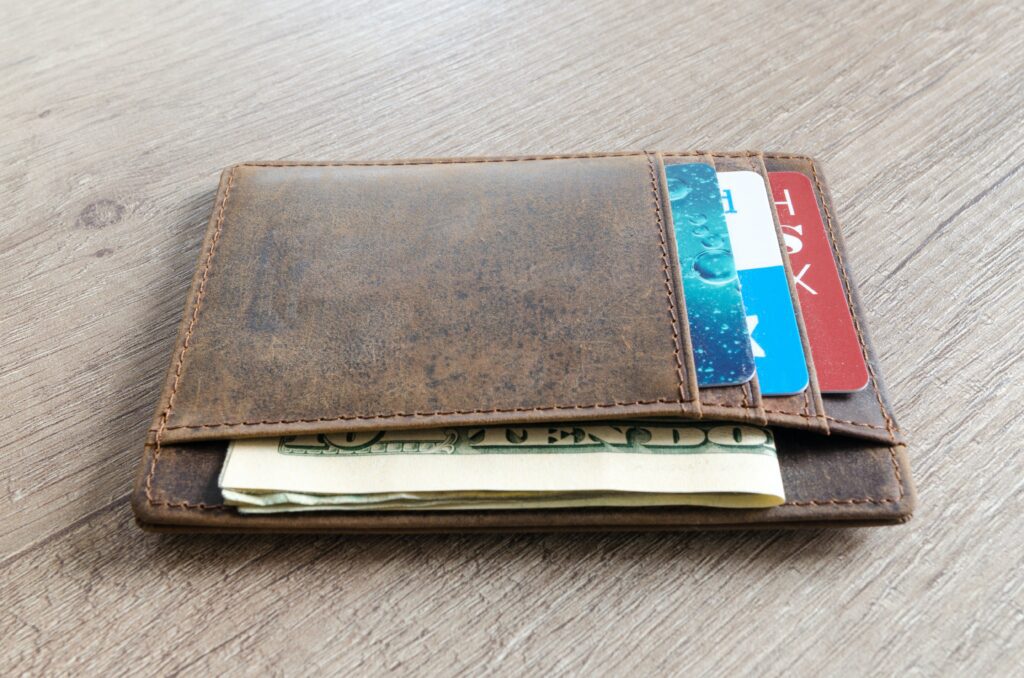 A thin wallet with a few bills and 3 credit cards. 