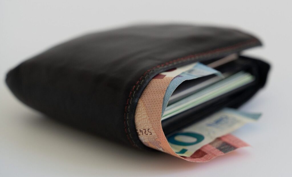 A wallet stuffed with money and a lot of credit cards.