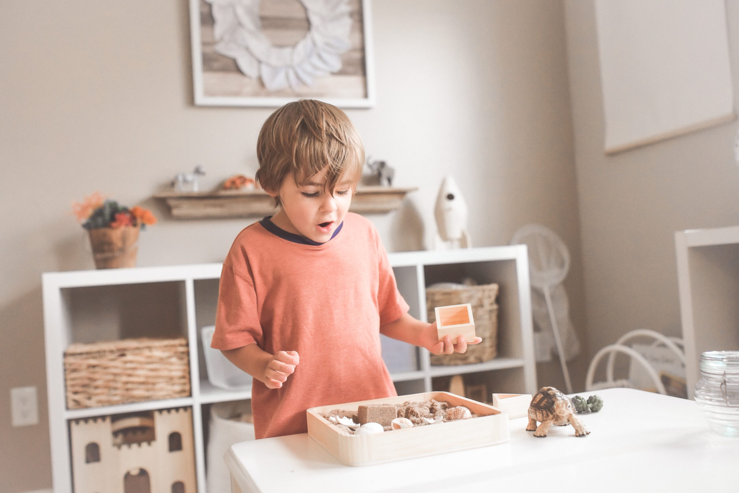 A young child excitedly exploring his toys